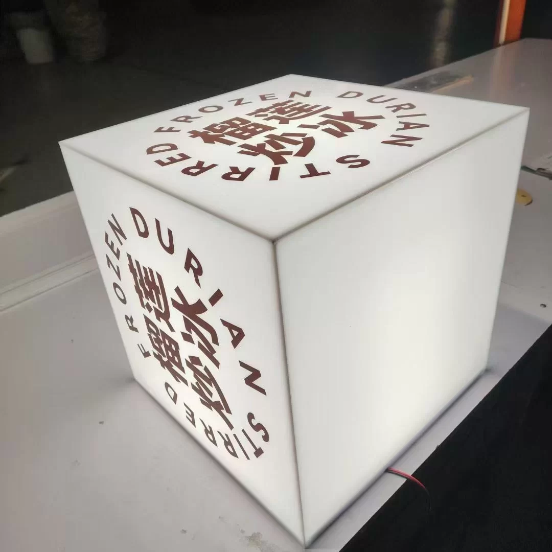 Custom acrylic cube lightbox with fully illuminated frosted faces on the Hongbo Signage production floor