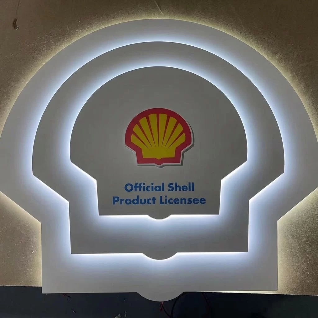 Custom stepped tiered backlit halo logo sign with multi-layer matte white finish and warm white LED glow, brand wall reception signage