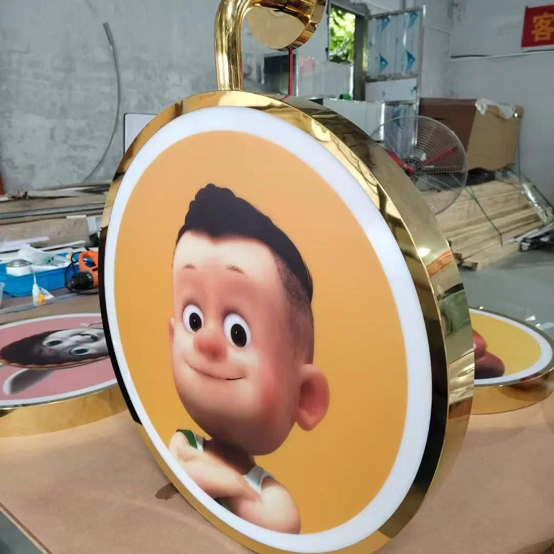 Custom mirror titanium gold lightbox sign with polished gold stainless frame on the Hongbo Signage production floor