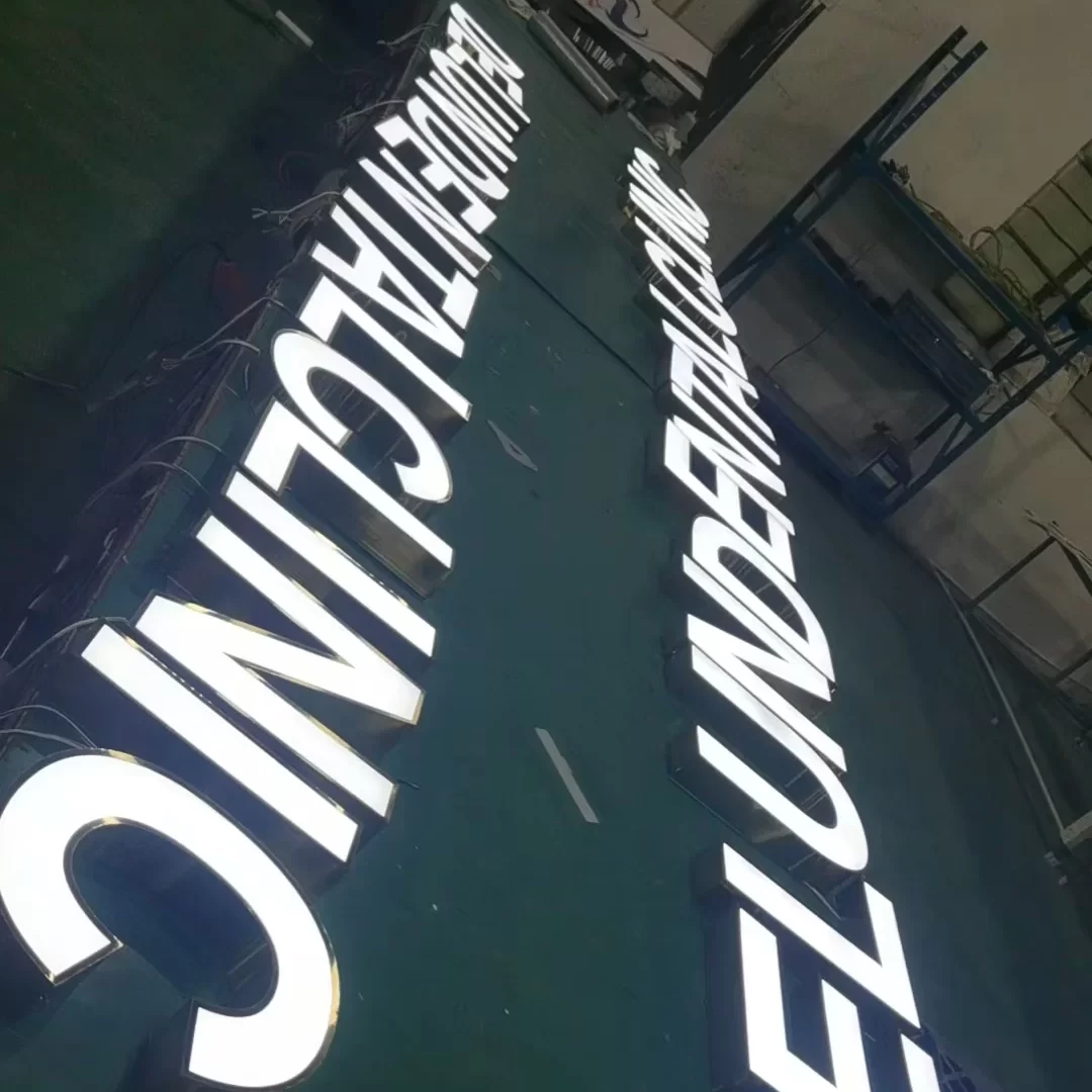 custom brushed stainless steel front-lit letters with flat acrylic illuminated face for dental clinic storefront